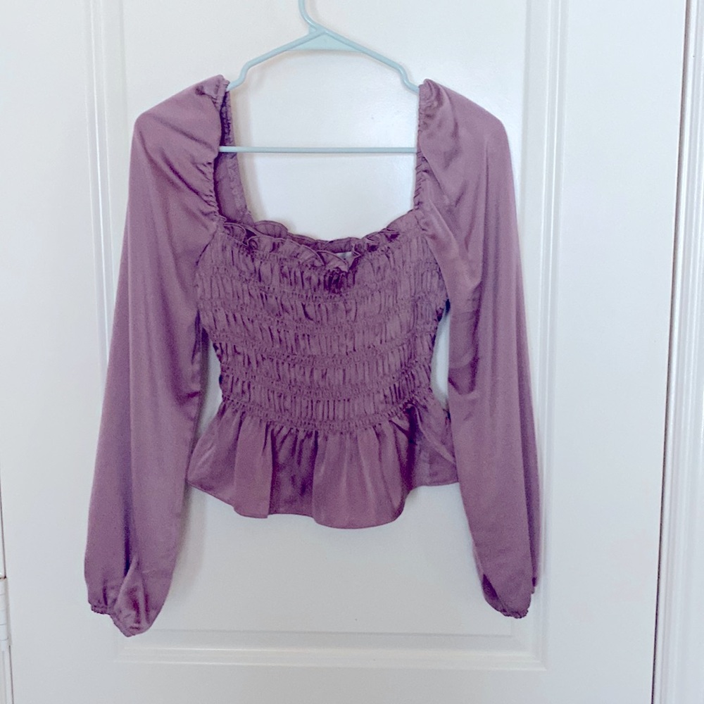 Long sleeve crop top. Tight fitted around torso.